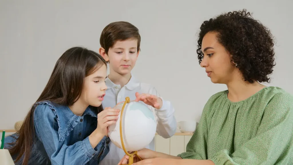 A group of kids standing around looking at something.