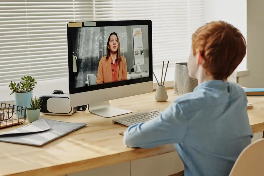 A person sitting at a desk with a computer